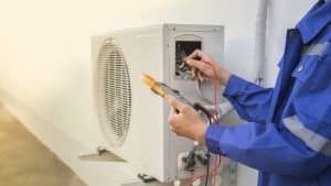 Technician checking the operation of the air conditioner